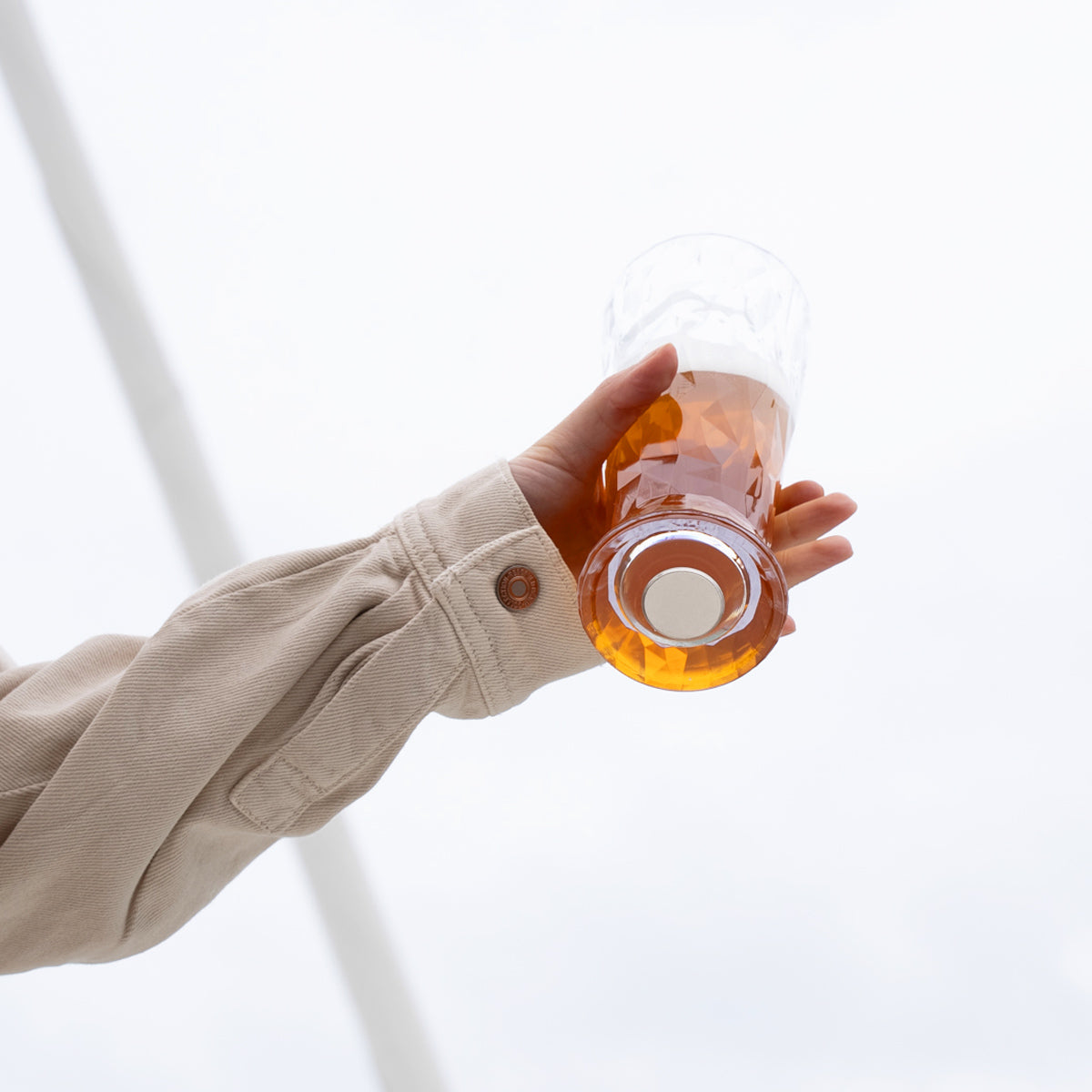 Magnet-Kristallglas Bier mit Magnet im Boden in die Luft gehalten